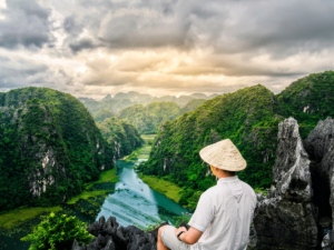 Tam Coc Trang An is famous for its breathtaking limestone mountains, peaceful rivers, and scenic boat tours through spectacular caves and lush countryside.