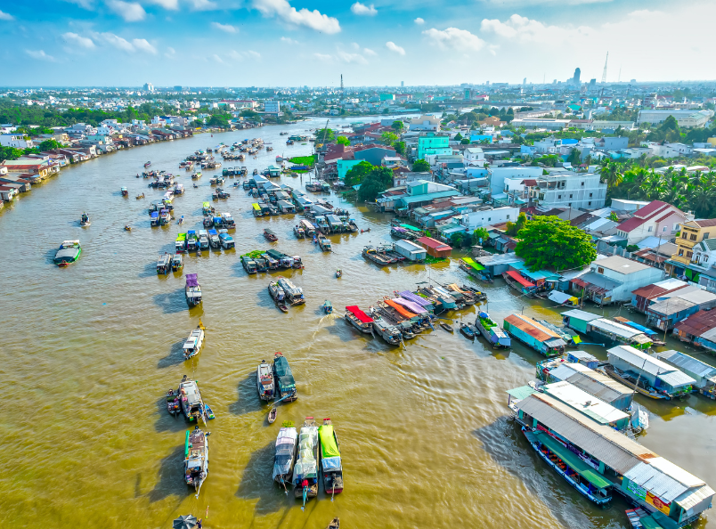 Experience the lively atmosphere of Cai Rang Floating Market, where colorful boats, fresh local produce, and authentic culture create unforgettable memories on a Southern Vietnam Tour.